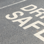 the message “drive safe” written on a road