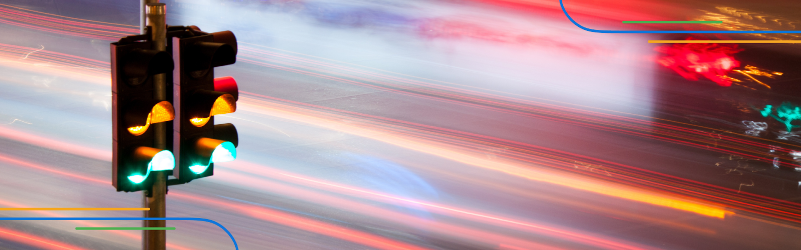 close-up of a traffic light with long exposure car lights behind it