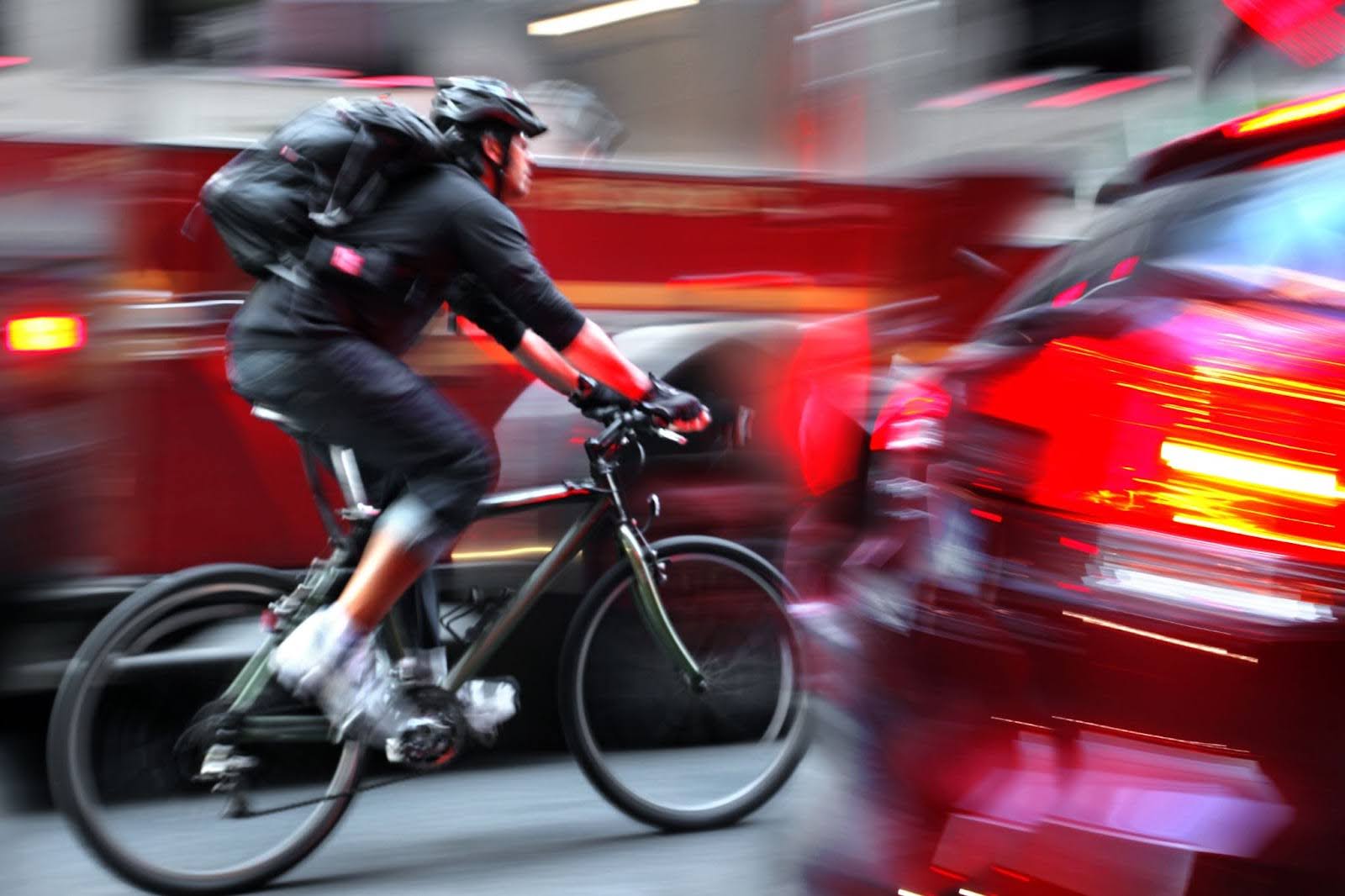 Bicyclist riding with traffic on an urban street