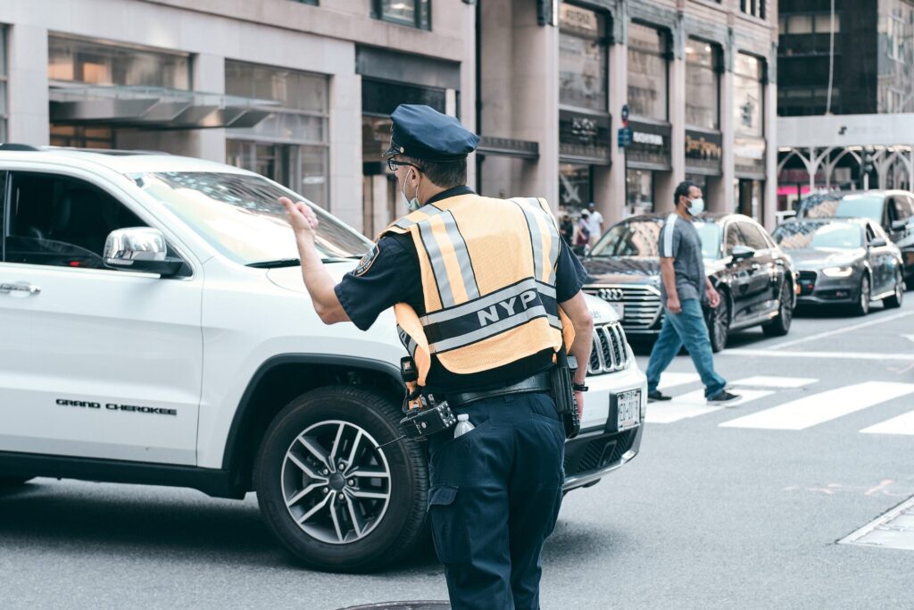 Police officer directing traffic without traffic light