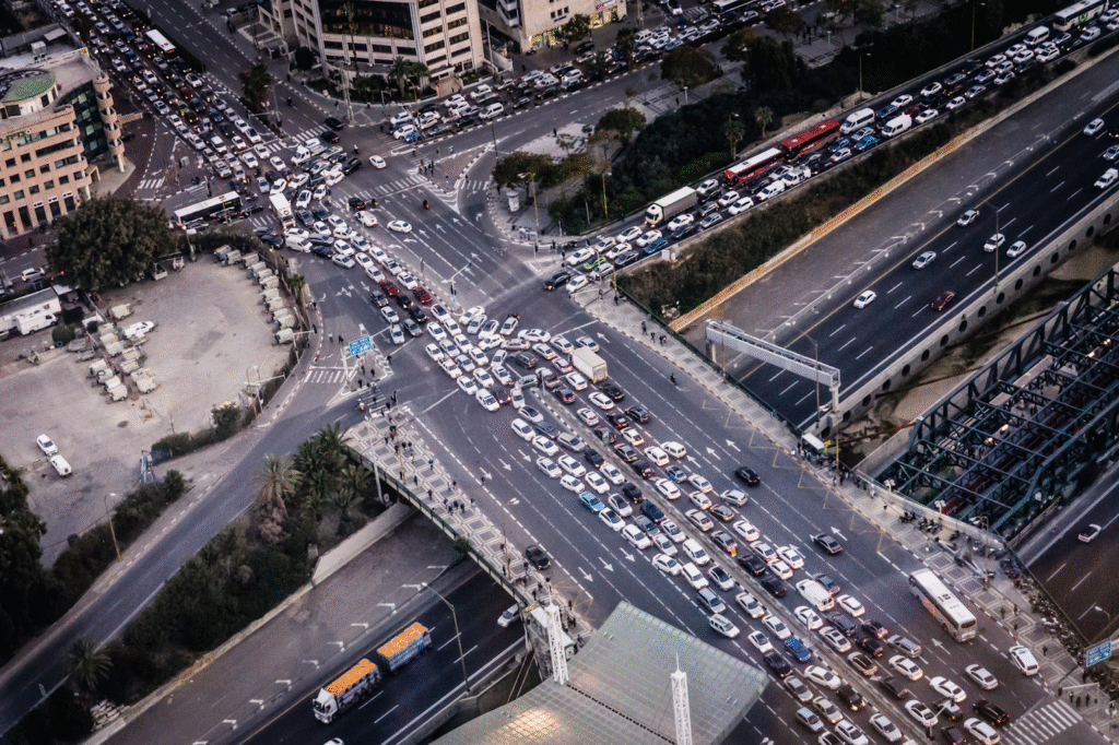 An aerial shot of a major city street piled with cars and trucks. 