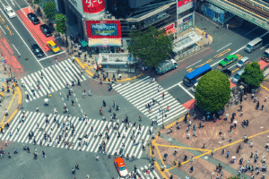 Pedestrians crossing at a busy metropolitan intersection.