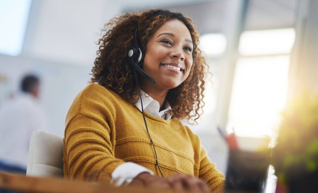 A smiling woman handles customer calls
