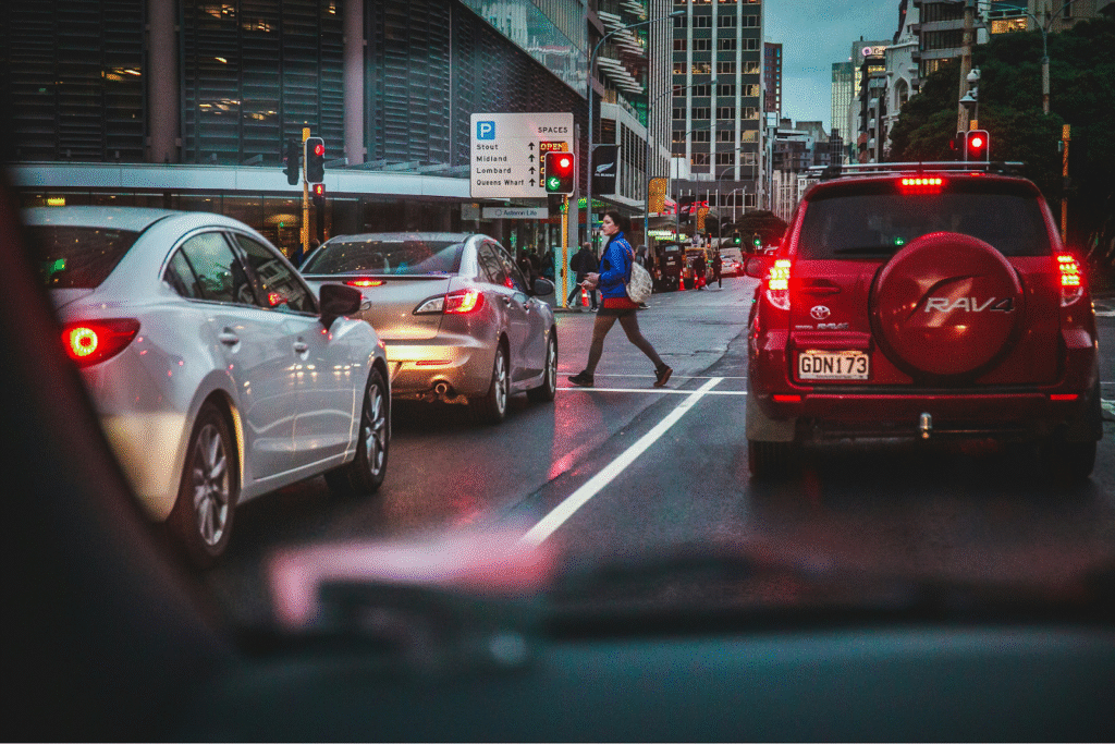 A person crossing an intersection as traffic waits
